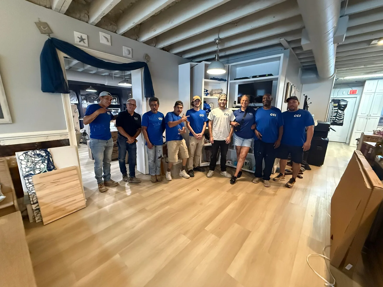 Tonya and the Coastal Contractors crew in their CCI shirts in the Waters Avenue showroom