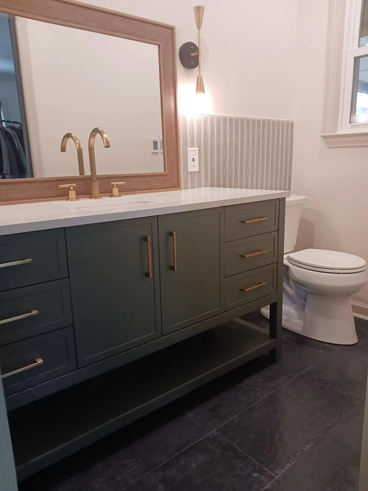 A green vanity with brass taps, midtown