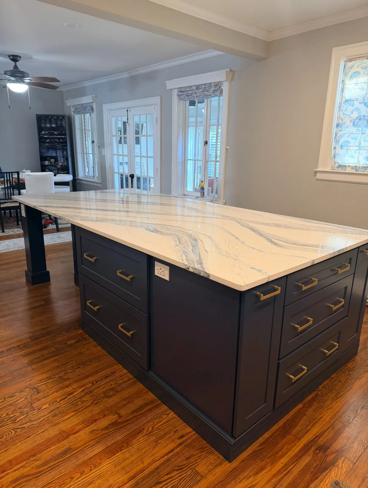 A navy island with a marble-look top, for homeowners who love to bake and entertain