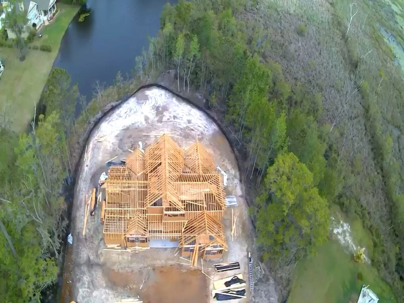 An aerial view of a large new home being framed