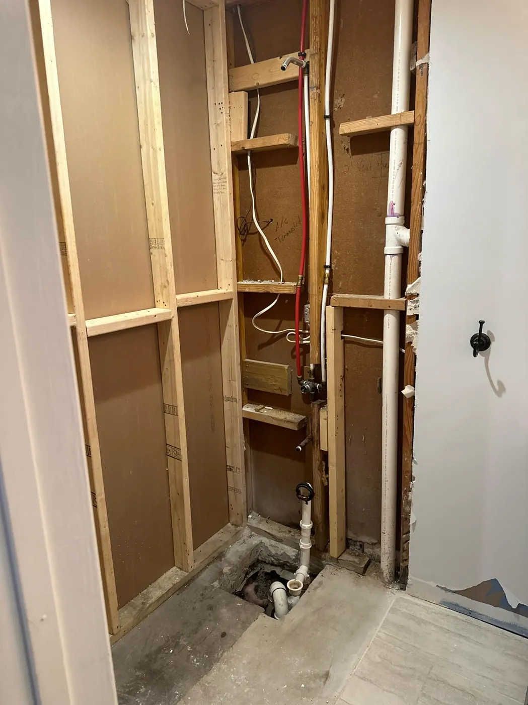 A bathroom wall opened up to the plumbing during a repair